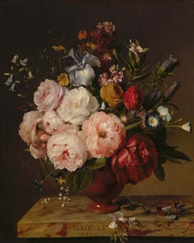 A VASE OF FLOWERS ON A LEDGE