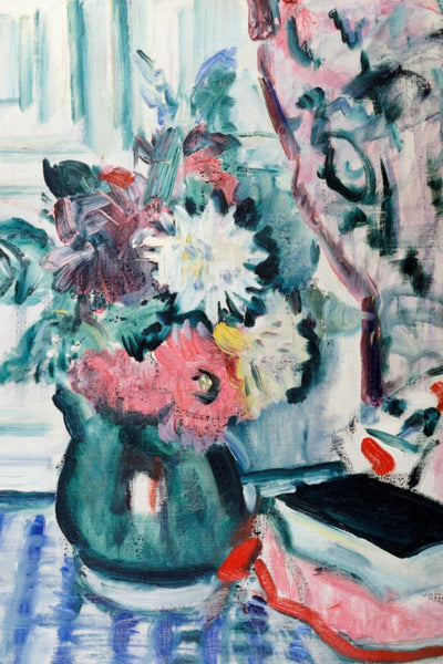 MIXED DAHLIAS IN A GREEN VASE WITH A BOOK ON A CHEQUERED TABLECLOTH